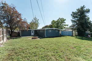 View of yard featuring a fire pit and a storage shed