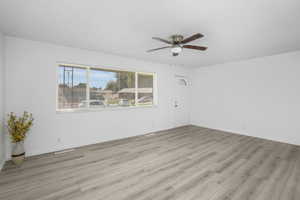 Spare room with ceiling fan and light wood-type flooring