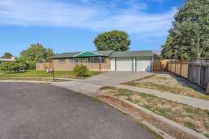 Ranch-style house with a front lawn and a garage