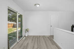 Dining room with light  vinyl wood-style flooring