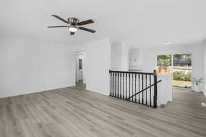 Interior space with light viny wood-type flooring and ceiling fan