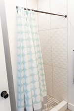 Bathroom with a shower with shower curtain