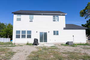 Back of house featuring central AC