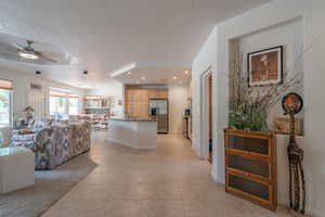 Interior space featuring a textured ceiling and light tile patterned floors