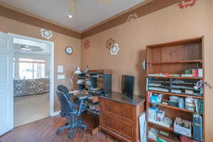 Office area featuring dark hardwood / wood-style flooring and ceiling fan