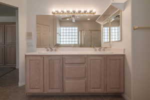 Bathroom featuring an enclosed shower, ceiling fan, vanity, and tile patterned floors