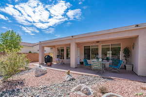 Rear view of property with ceiling fan and a patio area