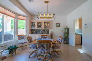 Tiled dining area with a notable chandelier