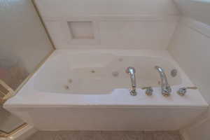 Bathroom featuring a bath and tile patterned flooring