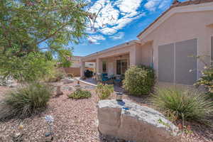 View of yard with ceiling fan and a patio