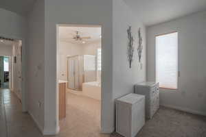 Hallway featuring light tile patterned flooring