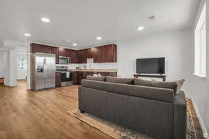 Living room with sink and light wood-type flooring