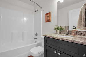 Full bathroom with vanity, toilet, and shower / washtub combination