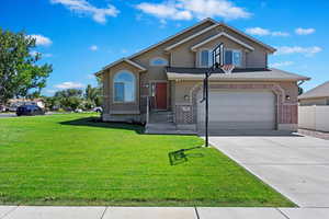 Front of property with a garage and a front yard