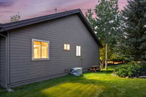 Property exterior at dusk featuring a yard