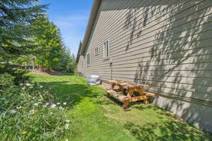 View of side of home featuring a yard