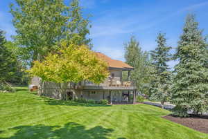 Back of house featuring a lawn