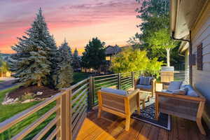 Deck at dusk featuring an outdoor living space