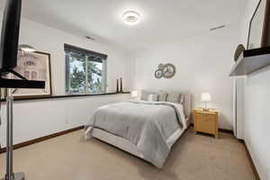 Bedroom with light colored carpet