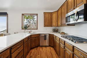 Kitchen featuring sink, appliances with stainless steel finishes, and light hardwood / wood-style floors