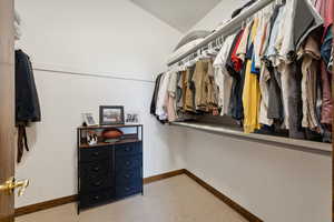 Walk in closet with carpet floors