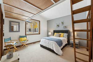 Carpeted bedroom with vaulted ceiling