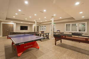 Game room featuring a raised ceiling