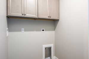 Clothes washing area with cabinets and hookup for an electric dryer