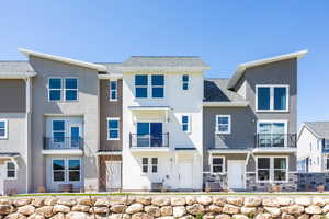 View of front of house with cooling unit