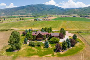 Birds eye view of property with a mountain view and a rural view