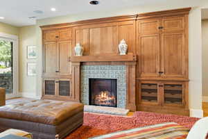 Living room featuring wood-type flooring and a tile fireplace