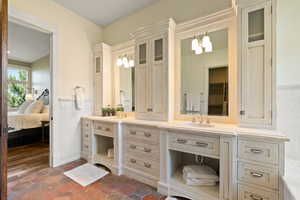 Bathroom with vanity, wood-type flooring, and a chandelier