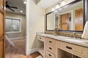 Bathroom featuring vanity, ceiling fan, and tile patterned flooring