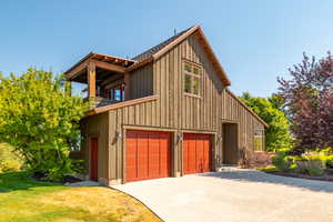 Exterior space featuring a garage and a yard