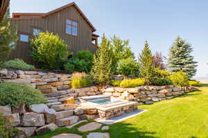 View of yard with an in ground hot tub