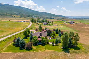 Birds eye view of property with a rural view and a mountain view