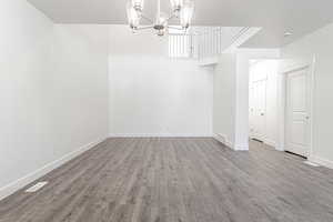 Interior space featuring hardwood / wood-style floors, a notable chandelier, and a textured ceiling