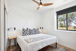 Bedroom featuring hardwood / wood-style floors and ceiling fan