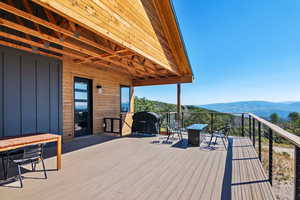 Wooden terrace with a mountain view and area for grilling