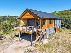 View of front of property featuring a wooden deck