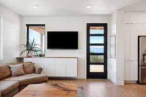 Living room with light hardwood / wood-style floors