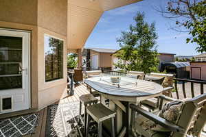 View of patio featuring a wooden deck and a shed