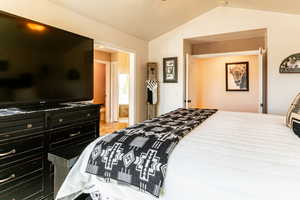 Bedroom featuring vaulted ceiling