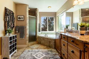 Primary Bathroom featuring vanity and separate shower and tub