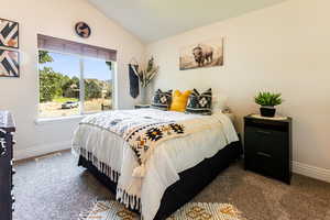 Bedroom number 2 featuring carpet flooring and vaulted ceiling