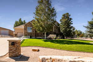 View of front facade featuring a garage and a front lawn