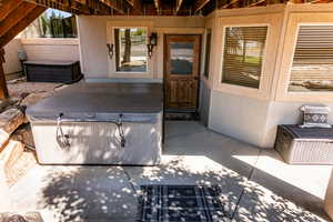 Back of property featuring a patio area and a hot tub