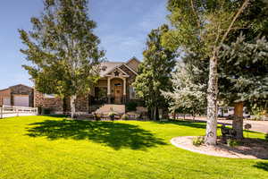 View of front of house with a front yard and a garage