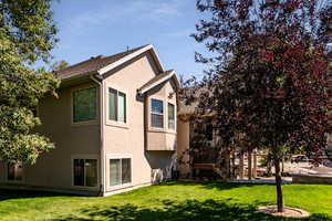 View of property exterior with a lawn