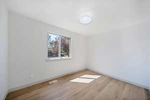 Empty room featuring light wood-type flooring